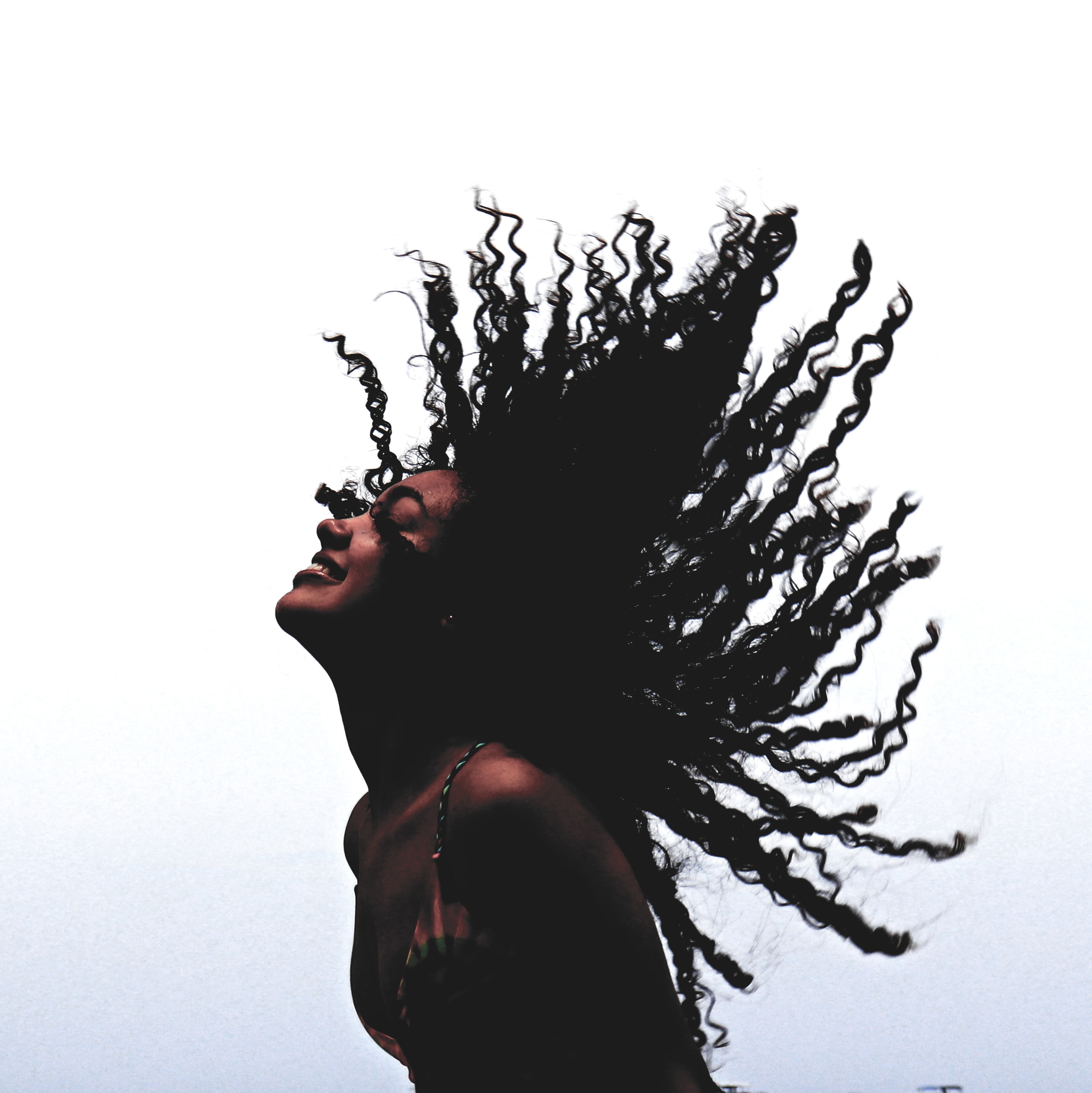 woman throwing hair back happily